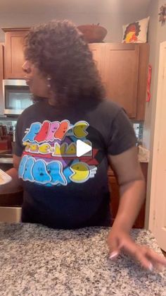 a woman standing in front of a kitchen counter