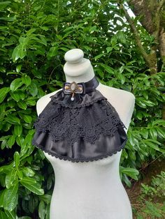 Beautiful Victorian era inspired elegant black lace jabot supplemented with grey cabochon and velvet bow will serve You well while enjoying a party or few that might require a proper dressing up. I suggest to experiment on a daily basis by combining elements to reach the goal - to impress. Detailed, hand crafted and carefully designed whit love and care!  This is a one of a kind piece and will certainly make your outfit unique.  Measurements:  Length - 12.5 inches width - 14-15 inches Closed wit Gothic Party Top With Lace Collar, Fitted Victorian Tops With Lace Collar, Gothic Sleeveless Corset With Ruffles, Victorian Ruffle Collar, Outfits Unique, Bib Collar, Velvet Bow, Victorian Era