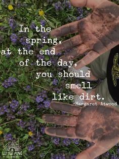 two hands with dirt on them are in the grass and there is a quote about it