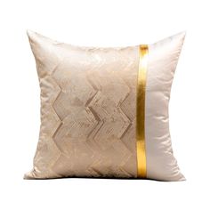 a gold and white pillow on a white background with a gold stripe down the side