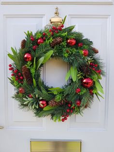 a christmas wreath hanging on the front door