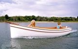 two people in a small boat on the water