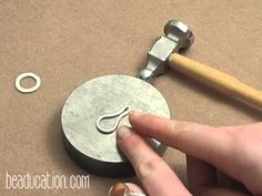 someone is making a metal object with scissors