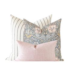 two pillows with pink and blue floral designs on the front, one is made out of linen