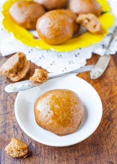 some muffins are on a white plate next to a bowl of muffins