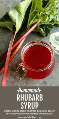 homemade rhubarb syrup in a glass jar next to green leaves