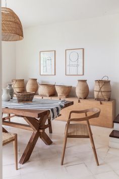 a table with vases and baskets on it