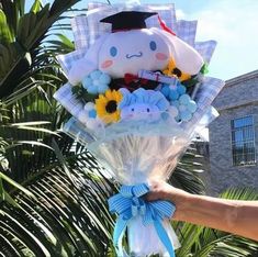 a person holding a bouquet of flowers in front of a palm tree with a stuffed animal on it