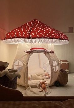 a child's room with a tent bed and toys on the floor in front of it