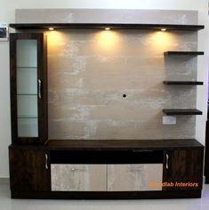 an entertainment center with shelves and lights on the wall