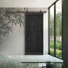 an empty room with a bamboo wall and sliding glass doors that open up to the outside