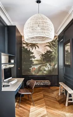 a room with wood floors and a painting on the wall