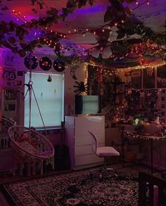 a living room filled with furniture and lights on the ceiling over a refrigerator freezer