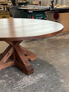 a round wooden table in a workshop