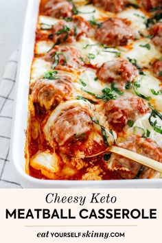 cheesy keto meatball casserole in a white dish with wooden spoons