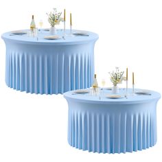 two round tables with blue tablecloths and gold place settings