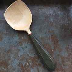 a wooden spoon sitting on top of a table