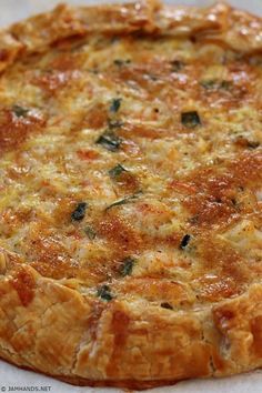 a quiche with cheese and herbs on top