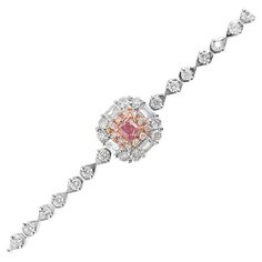 18K White Gold Cushion-Cut Fancy Pink Diamond Bracelet with Diamonds 1 Pink Diamond - 0.15 CT Diamonds - 0.92 CT (VS; F Colour) 18K Gold - 4.9 GM The pink diamond is a captivating and rare gemstone, its hue evoking the most delicate and precious things in nature. Regarded as one of the most sought-after diamonds, the pink diamond is a symbol of elegance, exclusivity, and refined taste. For this exquisite bracelet, we have carefully selected a vivid pink 0.15CT diamond, whose radiant color seems Formal Pink Diamond Bracelet With 17 Jewels, Formal Pink Bracelets With Diamond Accents, Luxury Pink Diamond Bracelet For Anniversary, Elegant Rose Gold Bracelet For Formal Occasions, Elegant Pink Gold Bracelet For Formal Occasions, Elegant Pink Diamond Bracelet For Formal Occasions, Pink Diamond Bracelet, Bracelet With Diamonds, Modern Bracelets