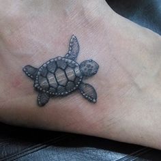 a small turtle tattoo on the foot