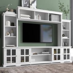 a white entertainment center with shelves and a flat screen tv mounted on it's side