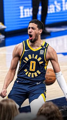 a basketball player with his mouth open in the middle of a court while people watch