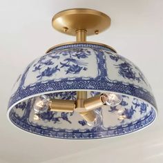 a blue and white light fixture hanging from the ceiling