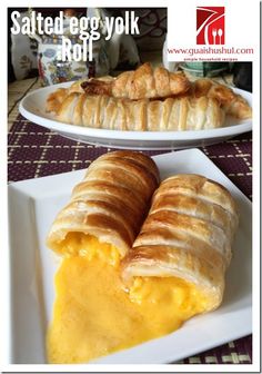 two white plates topped with croissants next to each other