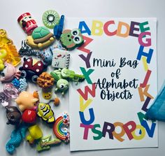 there is a sign that says mini bag of alphabet objects next to some small toys