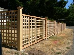 a large wooden fence in the middle of a yard