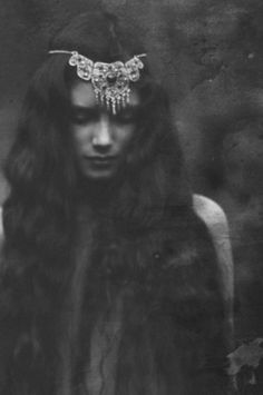 black and white photograph of a woman with long hair wearing a tiara on her head