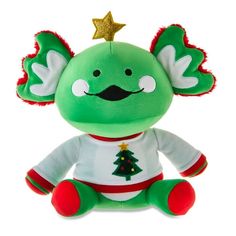 a green stuffed animal with a christmas tree on it's head and ears, sitting in front of a white background