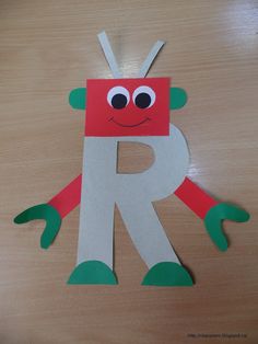 the letter r is made out of paper with eyes and hands on top of it