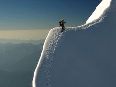 a man standing on the side of a snow covered mountain next to a quote from an unknown person