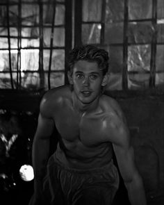 a black and white photo of a shirtless man