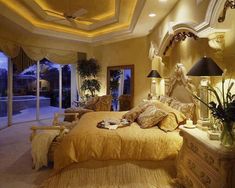 a large bed sitting in the middle of a bedroom next to two lamps on either side of it