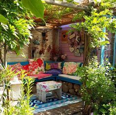 an outdoor seating area with colorful cushions and pillows