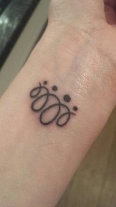 a woman's wrist with a tattoo on it that has the word boo written in cursive letters