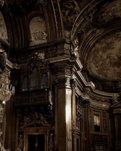 an ornately decorated room with chandeliers and paintings on the walls, in black and white