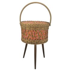 a wicker basket sitting on top of a wooden stand