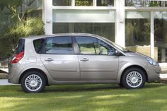 a small silver car parked in front of a building