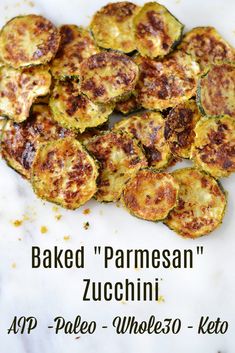 baked parmesan zucchini on a marble countertop with the words baked parmesan zucchini above it