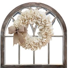 a wreath is hanging on the window sill