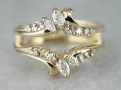 two gold wedding rings with diamonds on them