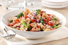 a white bowl filled with pasta and vegetables