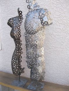 two metal sculptures sitting on top of each other