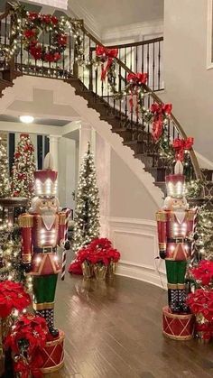 christmas decorations are displayed in front of the stairs