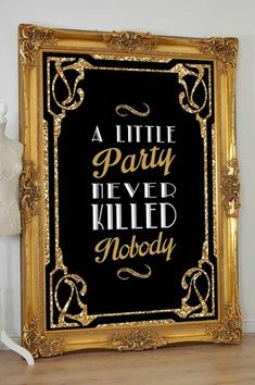 a little party never killed nobody sign in gold and black on a wooden floor next to a white mannequin