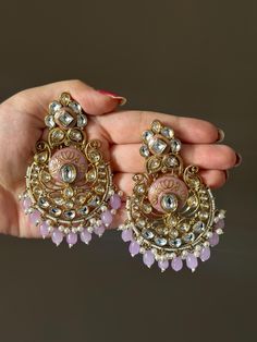 Step into a world of regal opulence with our exquisite Royal  Kundan Earrings. These stunning earrings embody the grandeur of Indian royalty, combining rich and vibrant hues with intricate Kundan craftsmanship. Handcrafted to perfection, these earrings feature lustrous Kundan stones that capture the essence of luxury. The harmonious blend of these majestic colors creates a captivating display of opulence and elegance. The golden framework enhances the allure, highlighting the meticulous attentio Jeweled Chandbali Chandelier Earrings For Celebration, Celebration Jeweled Chandbali Chandelier Earrings, Bollywood Chandbali Jeweled Earrings, Ornate Jeweled Earrings For Festive Occasions, Ornate Round Chandelier Earrings For Wedding, Elegant Round Meenakari Chandelier Earrings, Ornate Chandbali Bridal Earrings, Ornate Round Danglers For Festive Occasions, Elegant Pink Chandbali Chandelier Earrings