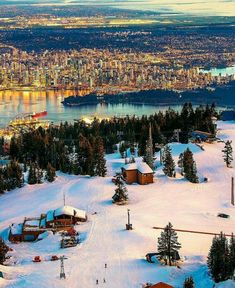 an aerial view of a ski resort in the mountains with snow on the ground and trees